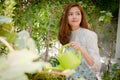 The girls are doing and garden watering On a bright day. Royalty Free Stock Photo