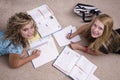 Girls doing homework looking up Royalty Free Stock Photo