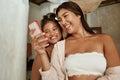 Girls Doing Selfie. Friends Using Smartphone For Taking Photo. Young Women Looking At Digital Device Screen And Smiling.