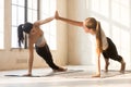 Girls doing side plank and holding hands Royalty Free Stock Photo