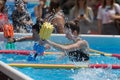 Girls Doing Water Aerobics with Floating Pool Dumbbells Outdoor in a Swimming Pool