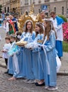 Girls dressed in blue traditional costumes at a procession for the Feast of Corpus Christi in Krakow, Poland