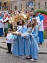 Girls dressed in blue traditional costumes at a procession for the Feast of Corpus Christi in Krakow, Poland