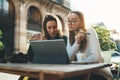 Girls drink coffee relax in cafe outdoor in europe city. Freelancer communicate on project, girls shopping online on wifi tablet Royalty Free Stock Photo