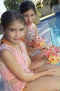 Girls Drinking Juice By Pool's Edge Royalty Free Stock Photo