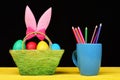 Girls Easter bunny ears in pink colour standing in basket Royalty Free Stock Photo
