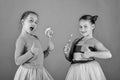 Girls eat big colorful sweet caramels. Children with happy faces Royalty Free Stock Photo