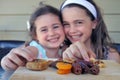 Girls Eating  Dried Fruit Together on Tu Bishvat Jewish Holiday Royalty Free Stock Photo