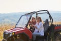 girls enjoying a beautiful sunny day while driving an off-road car Royalty Free Stock Photo