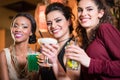 Girls enjoying nightlife in a club, drinking cocktails Royalty Free Stock Photo