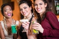 Girls enjoying nightlife in a club, drinking cocktails Royalty Free Stock Photo