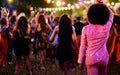 Girls enjoying summer night music party with DJ in open air disco