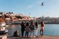 Girls enjoying the views of the Portuguese Ribeira while a bird passes by.