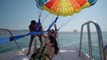 girls are excited before take off at para sailing with a rope pulled by a boat