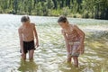 Girls Exploring Bottom Of Lake With Sticks