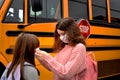 Coronavirus school: with facemasks by school bus