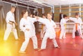 Girls fighting in pair to use new karate techniques during class Royalty Free Stock Photo