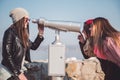 Girls fooling around with panorama binoculars