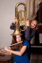 Girls fooling with musical instruments