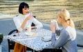 Girls friends drink coffee and talk. True friendship friendly close relations. Conversation of two women cafe terrace