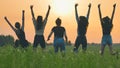 Girls friends are jumping against the background of an evening summer sunset. Royalty Free Stock Photo