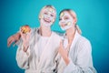 Girls friends sisters making clay facial mask. Anti age mask. Stay beautiful. Skin care for all ages. Women having fun Royalty Free Stock Photo