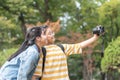 Girls friends, teenager school students with digital camera selfie in the park for vlog, video blog for traveling review