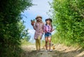 Girls with gardening tools. Agriculture concept. Adorable girls in hats going planting plants. Sisters helping at farm