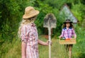 Girls with gardening tools. Summer at countryside. Sisters helping at backyard. Child friendly garden tools ensure