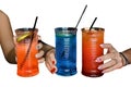 Girls girlfriends holds drink alcoholic bright summer color cocktails in her hands, close-up on white isolated background Royalty Free Stock Photo