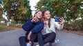 Girls girlfriends teenagers, summer park, photos smartphone, happy smiling, having fun playing. Selfie phone. Record