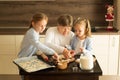 Girls with grandma are preparing Christmas cookies in the kitchen Royalty Free Stock Photo