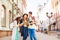 Girls and guy holding camera look at city map