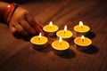 A girls hand arranging Tea lights candles Royalty Free Stock Photo