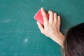 Girls hand in elementary school cleaning board with sponge Royalty Free Stock Photo