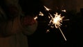 Girls hand waving sparkler