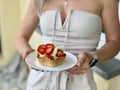 Girls hands hold a basket with ice cream and strawberries Royalty Free Stock Photo