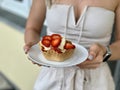 Girls hands hold a basket with ice cream and strawberries Royalty Free Stock Photo