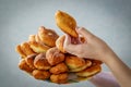 Girls hands hold a plate with fried pies and offer to eat them