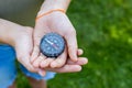 Girls hands holding the compass. Hands of a teenager girl holding a liquid compass. Red compass needle points north Royalty Free Stock Photo