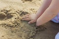 Girls hands playing in the sand at the beach. Royalty Free Stock Photo