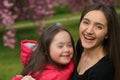 Girls have fun in the park of blooming sakura