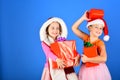 Girls have winter holidays, copy space. Sisters in Santa hats Royalty Free Stock Photo