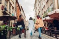 Girls having fun. Outdoor shot of three young women walking on city street. Back view Royalty Free Stock Photo