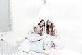 Girls having fun tipi house. Girlish leisure. Sisters share gossips having fun at home. Cozy place tipi house. Sisters Royalty Free Stock Photo