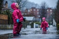 Girls are having fun in water on street in cold autumn day, girls splashing water in rain, cheerful girls enjoying cold weather Royalty Free Stock Photo