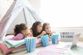 Girls Having Popcorns While Watching Movie On Laptop In Tipi