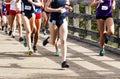 Girls high school cross country race running on a bridge