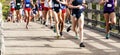 Girls high school cross country race running on a bridge Royalty Free Stock Photo