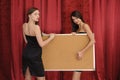 Girls hold empty board Royalty Free Stock Photo